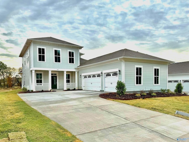 view of front of home featuring a porch, a garage, and a front yard