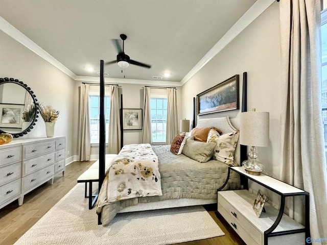 bedroom with light wood-type flooring, ceiling fan, and ornamental molding