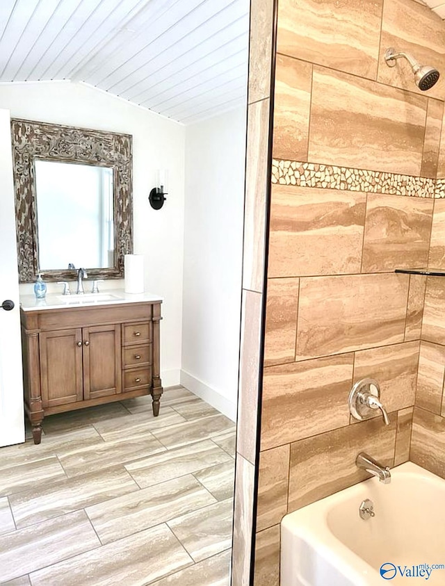 3635 Buck Island Dr, Guntersville, AL 35976 - full bath featuring vaulted ceiling, vanity, baseboards, wood finished floors, and shower / bathtub combination