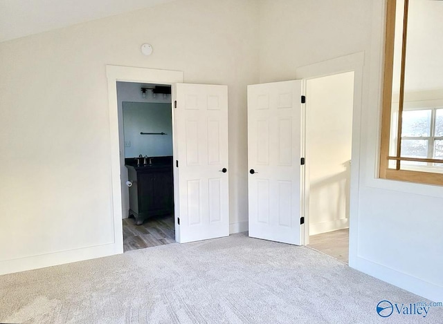 3635 Buck Island Dr, Guntersville, AL 35976 - unfurnished bedroom featuring carpet, a sink, ensuite bathroom, and baseboards