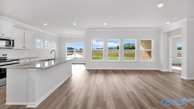 307 Wraywood Rd, Huntsville, AL 35810 - kitchen featuring stainless steel appliances, light stone countertops, an island with sink, white cabinets, and light wood-style floors