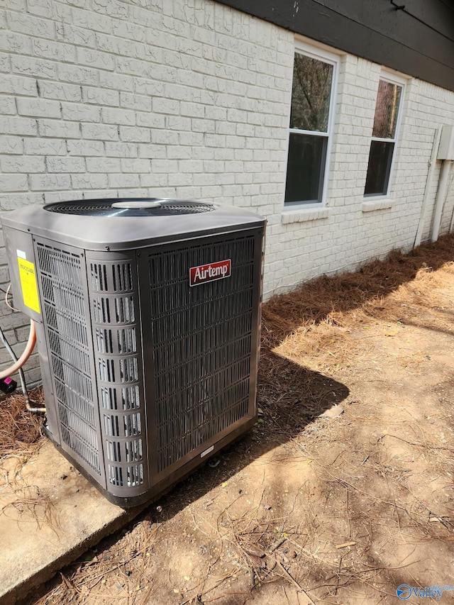 exterior details featuring central air condition unit and brick siding