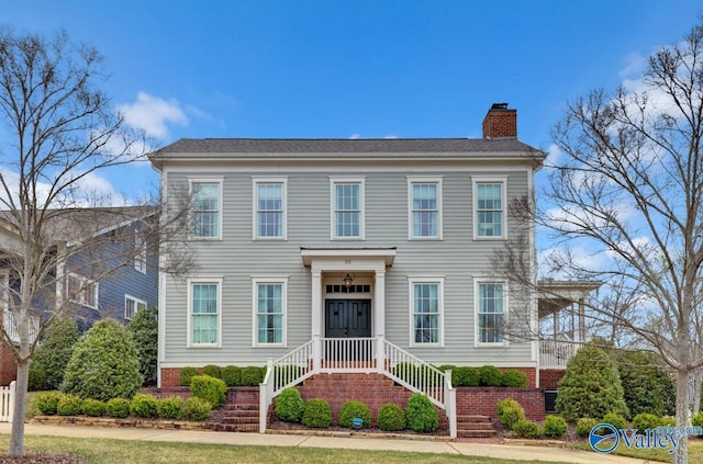 colonial house featuring a chimney