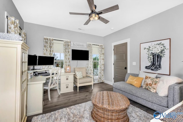 interior space featuring a ceiling fan, wood finished floors, and baseboards