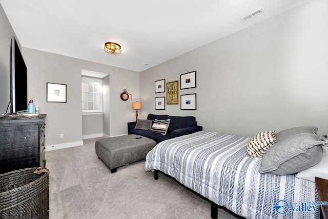 carpeted bedroom with visible vents and baseboards