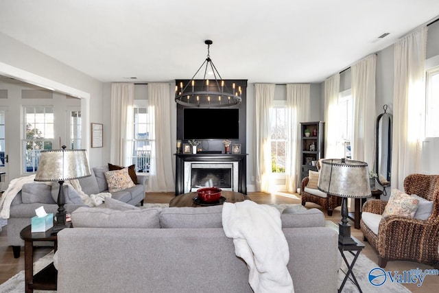 living room featuring a notable chandelier and a fireplace