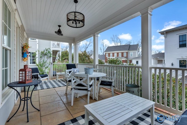 exterior space with wooden ceiling, plenty of natural light, and ornate columns