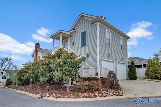 view of front of house with stairway, concrete driveway, and an attached garage