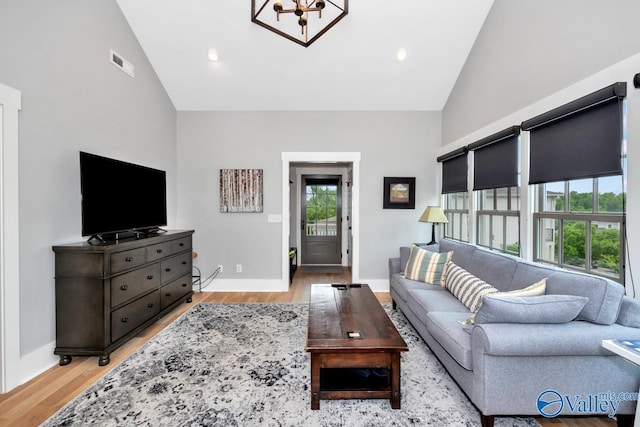 living room with visible vents, high vaulted ceiling, recessed lighting, light wood-style floors, and baseboards