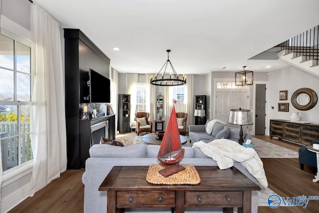 living room featuring plenty of natural light, a fireplace, and wood finished floors