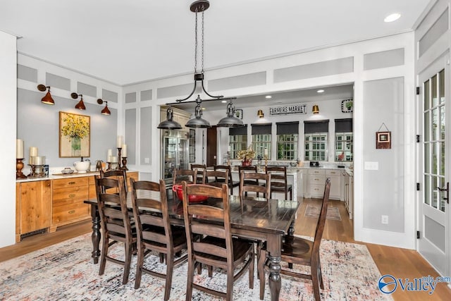 dining space with recessed lighting and light wood-style flooring