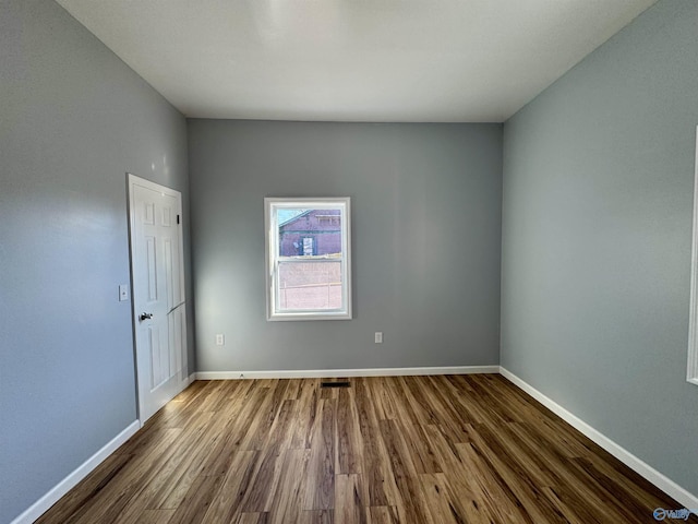 unfurnished room featuring hardwood / wood-style flooring