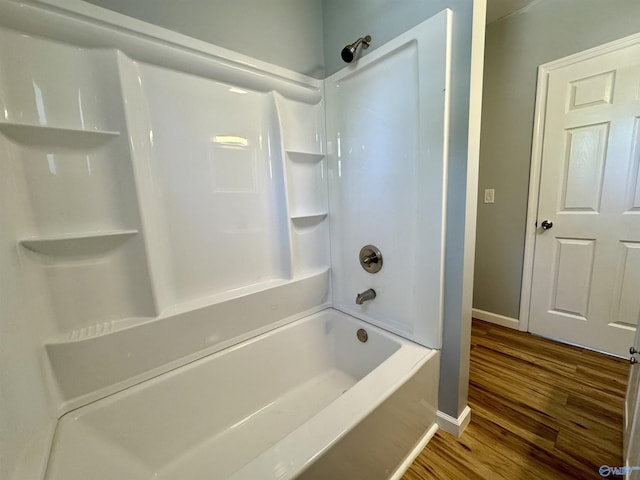 bathroom featuring hardwood / wood-style flooring and tub / shower combination