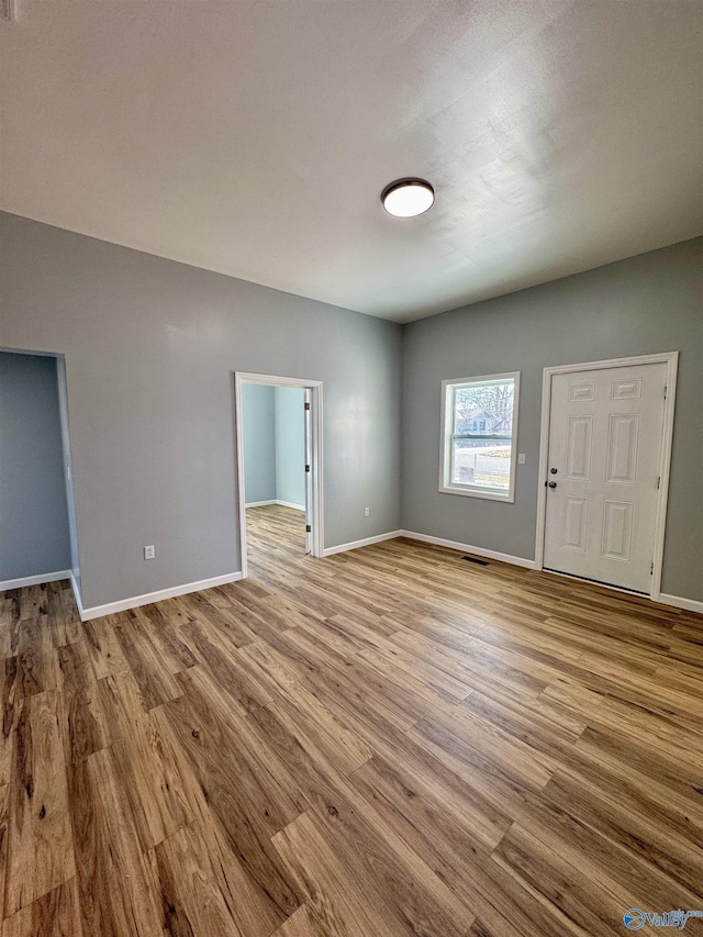 unfurnished room with light wood-type flooring