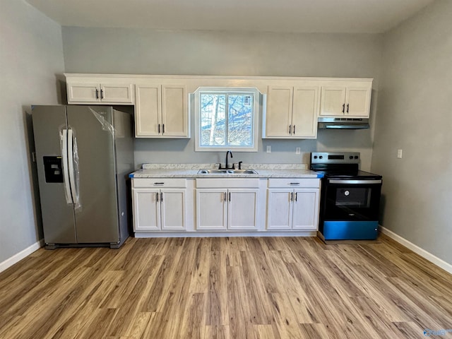 kitchen featuring white cabinets, appliances with stainless steel finishes, light hardwood / wood-style flooring, and sink