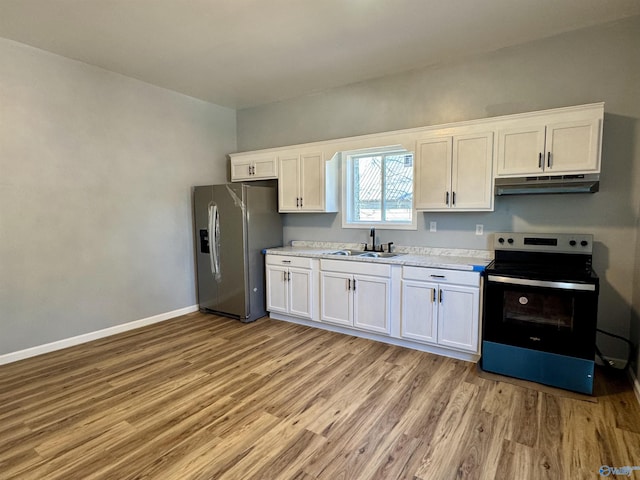 kitchen with sink, white cabinets, light wood-type flooring, and appliances with stainless steel finishes