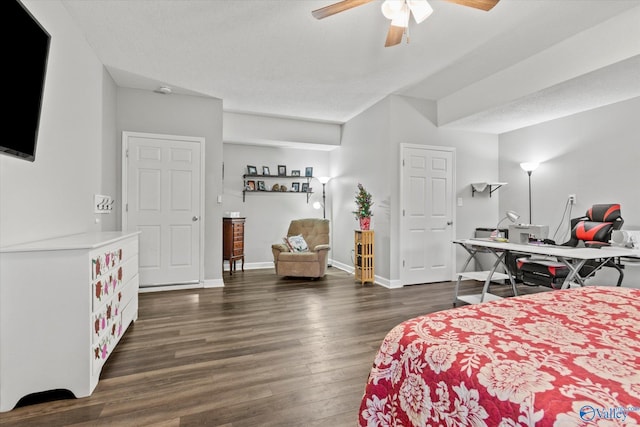 bedroom with ceiling fan, dark hardwood / wood-style floors, and a textured ceiling