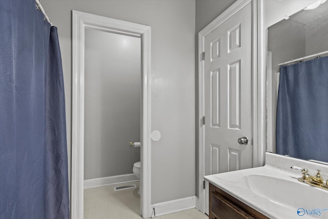 bathroom featuring vanity and toilet