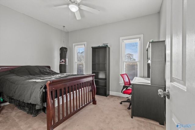 bedroom featuring multiple windows, ceiling fan, and light colored carpet