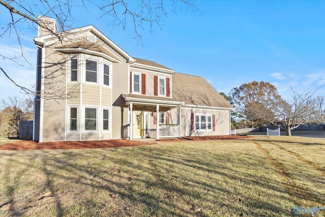 view of front of home featuring covered porch and a front yard