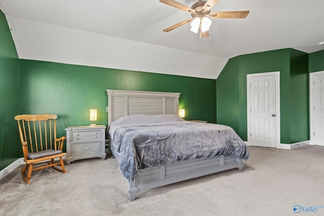 carpeted bedroom with a textured ceiling, ceiling fan, and vaulted ceiling