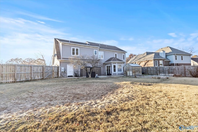 rear view of property with an outbuilding