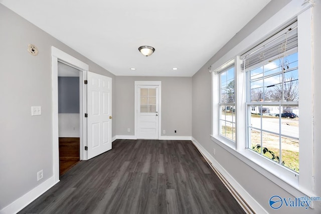 interior space featuring recessed lighting, dark wood finished floors, and baseboards