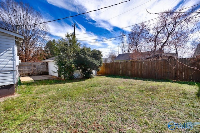 view of yard featuring a fenced backyard and an outdoor structure