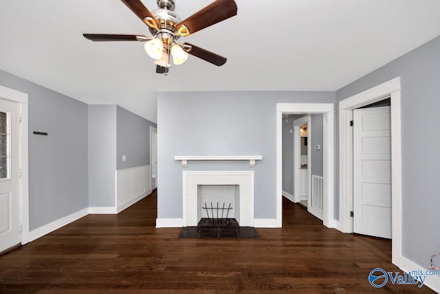 unfurnished living room featuring a brick fireplace, ceiling fan, baseboards, and wood finished floors