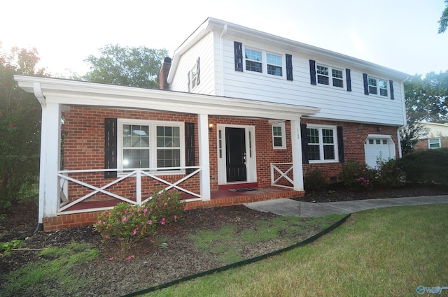 view of front of property with a garage and a front lawn