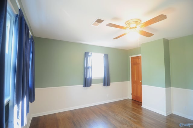 unfurnished room with ceiling fan and dark hardwood / wood-style floors