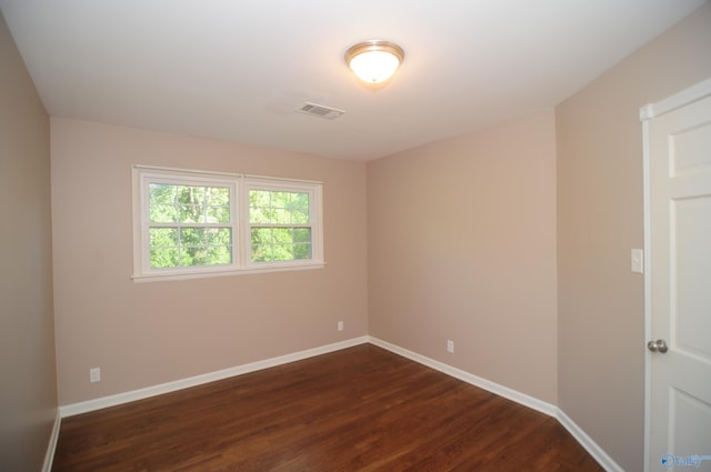 unfurnished room featuring dark hardwood / wood-style floors