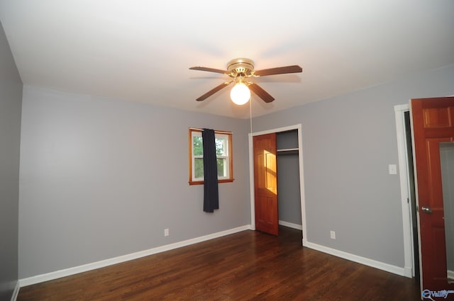 unfurnished bedroom with a closet, ceiling fan, and dark hardwood / wood-style floors