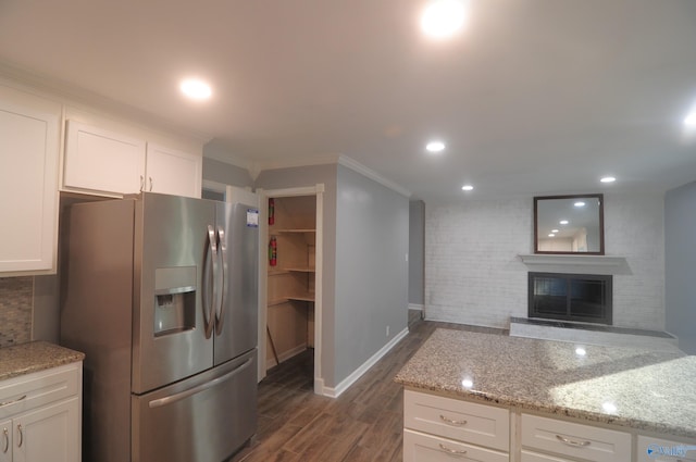 kitchen featuring crown molding, white cabinetry, dark hardwood / wood-style flooring, light stone countertops, and stainless steel fridge with ice dispenser