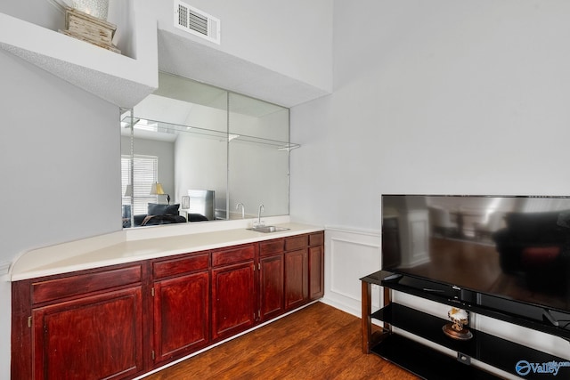 kitchen featuring a peninsula, visible vents, light countertops, and a sink