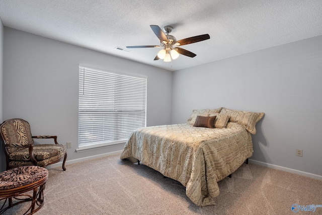 carpeted bedroom with visible vents, ceiling fan, a textured ceiling, and baseboards