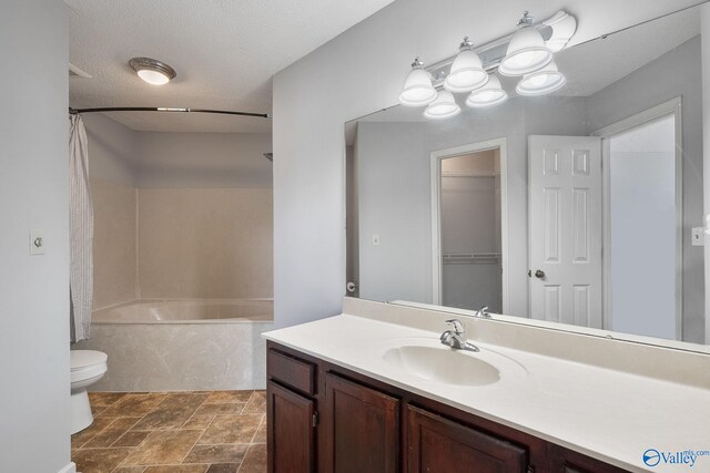 full bathroom with vanity, tile patterned floors, toilet, a textured ceiling, and bathtub / shower combination