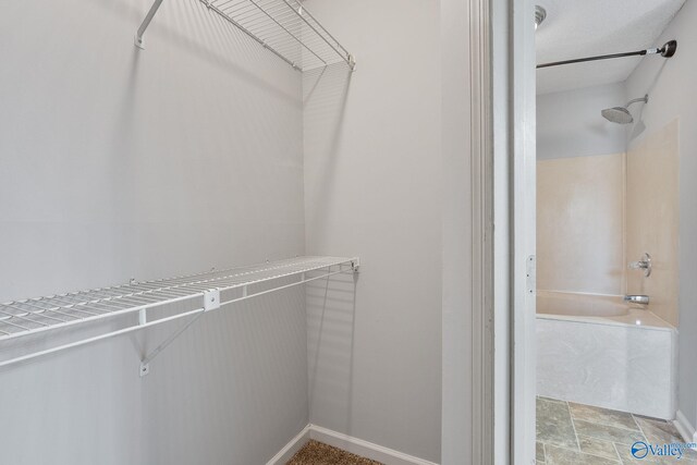 walk in closet featuring tile patterned flooring