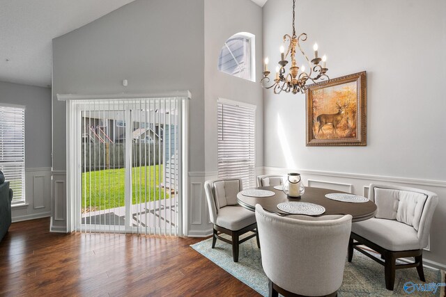 dining area with sink, ceiling fan with notable chandelier, and hardwood / wood-style floors