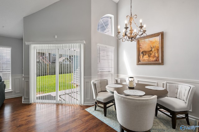 dining space featuring vaulted ceiling, dark wood-style flooring, and plenty of natural light