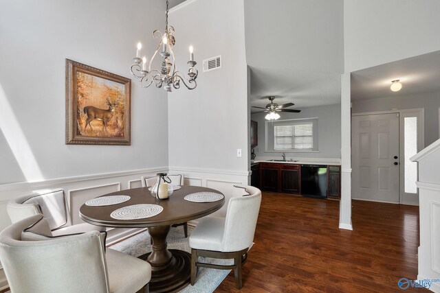 dining space with an inviting chandelier, high vaulted ceiling, and dark wood-type flooring