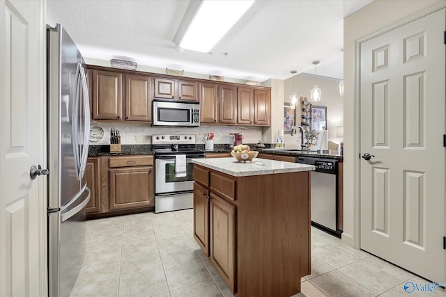 12100 Two Rivers Dr Phi, Phi, Athens, AL 35611 - kitchen with appliances with stainless steel finishes, decorative backsplash, a kitchen island, light tile patterned flooring, and dark stone counters