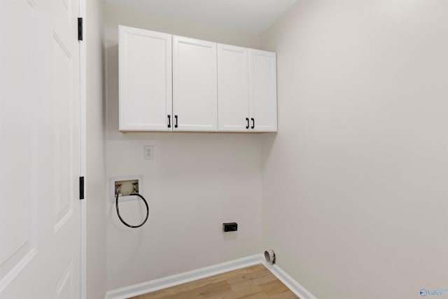 laundry room featuring cabinets, hookup for an electric dryer, hookup for a washing machine, and light hardwood / wood-style flooring