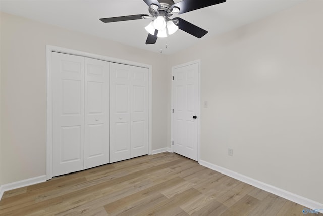 unfurnished bedroom with ceiling fan, light hardwood / wood-style flooring, and a closet