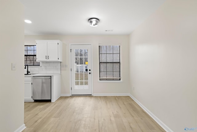 entryway with light hardwood / wood-style flooring and sink