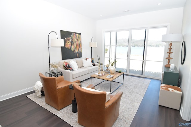 living area with recessed lighting, wood finished floors, and baseboards