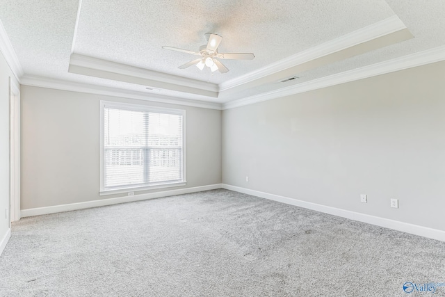 empty room featuring ornamental molding, ceiling fan, and a raised ceiling