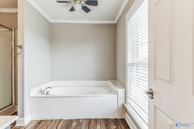 bathroom with ceiling fan, shower with separate bathtub, hardwood / wood-style floors, and ornamental molding