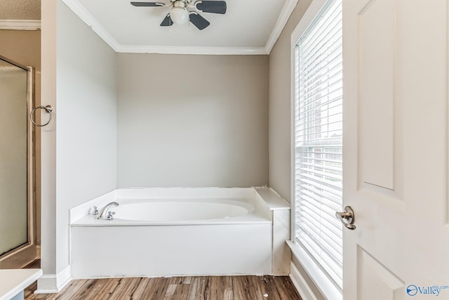 full bath with an enclosed shower, a garden tub, crown molding, and wood finished floors