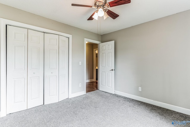 unfurnished bedroom with a ceiling fan, baseboards, a closet, and light colored carpet